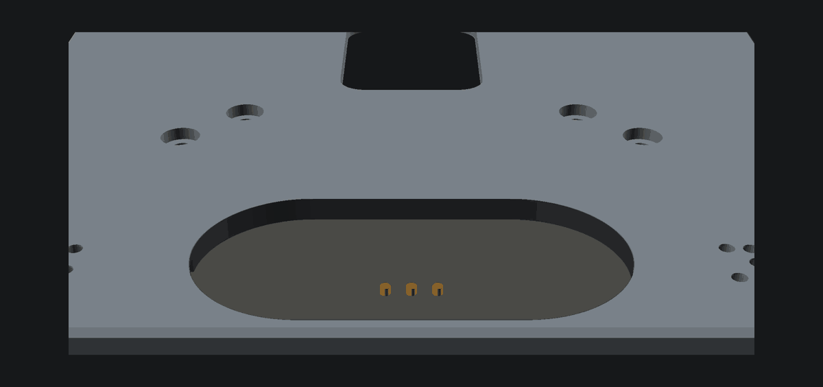 Charging puck seated flush with three gold pogo contacts standing proud